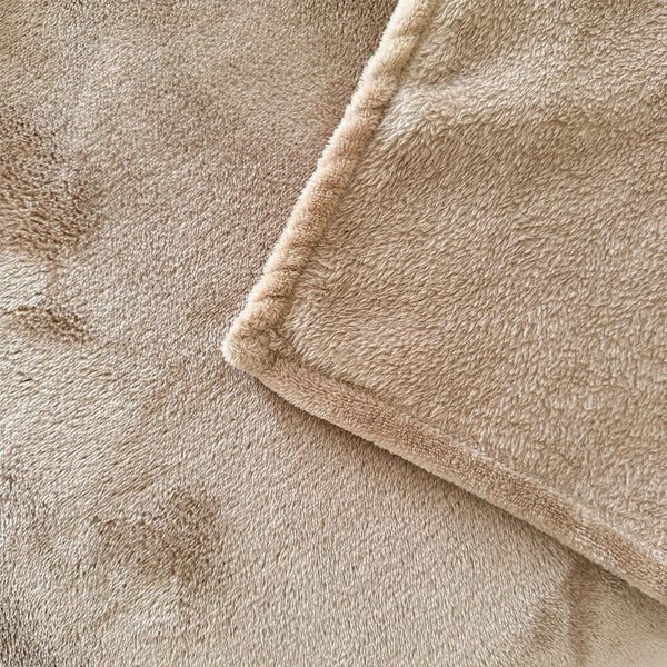 A plush blanket that is tan has a close-up to show its detail - Fleece Chic