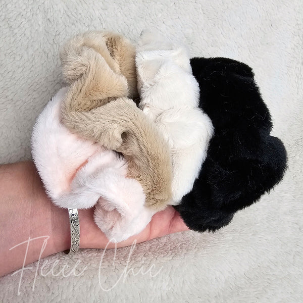 Fluffy scrunchies in different colors are photographed together - Fleece Chic
