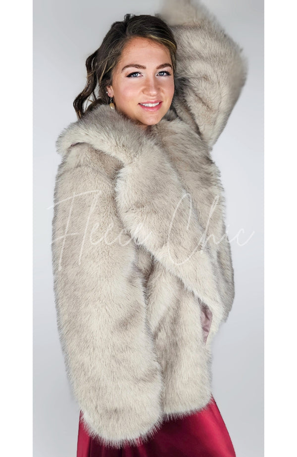 A woman poses in a fox fur coat and red silk dress - Fleece Chic