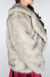 A woman wears a fox fur coat and displays its side for the camera - Fleece Chic