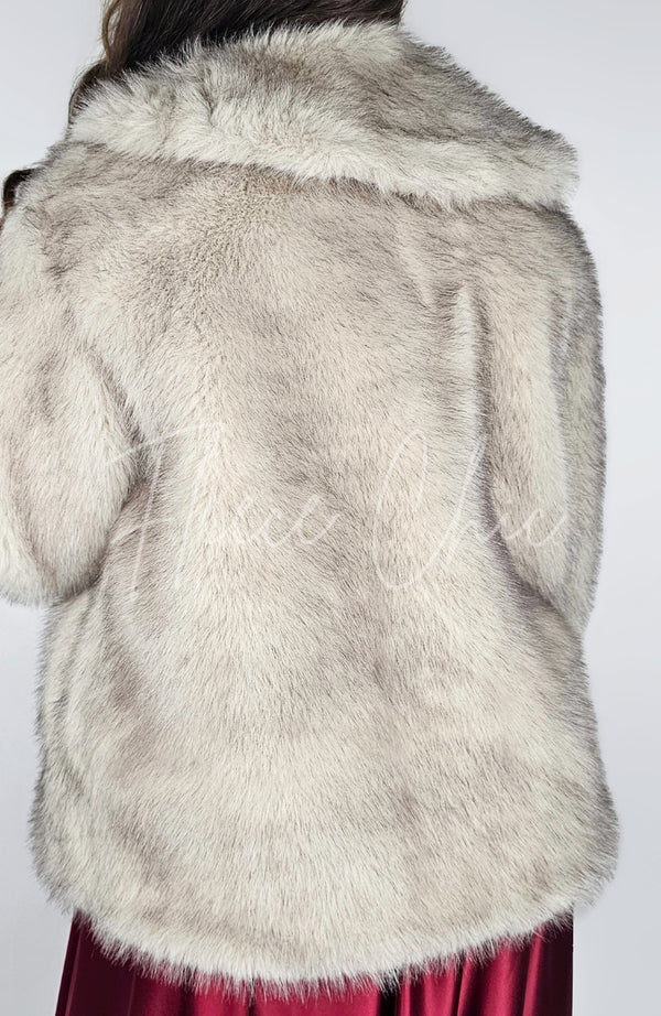 A woman wears a fox fur coat and displays the back for the camera - Fleece Chic