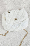 A detailed close up of a fur purse that is white with diamond patterns on it and golden details - Fleece Chic