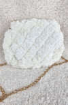 A close-up detailed image of a beautiful fur purse that is white with a golden chain by Fleece Chic shown from its rear view.