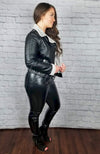 A woman shows her side profile while dressed in Fleece Chic's Vegan Leather Jacket and their Thermal Leather Leggings.