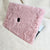 Pink fluffy MacBook laptop cover by Fleece Chic with plush faux fur design on a white background.