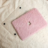 A laptop cover that is ultra plush rabbit faux fur by Fleece Chic on a white sherpa background.