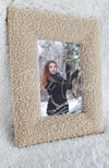 A stylish picture frame in the color Oatmeal by Fleece Chic with the image of a woman in snow framed.