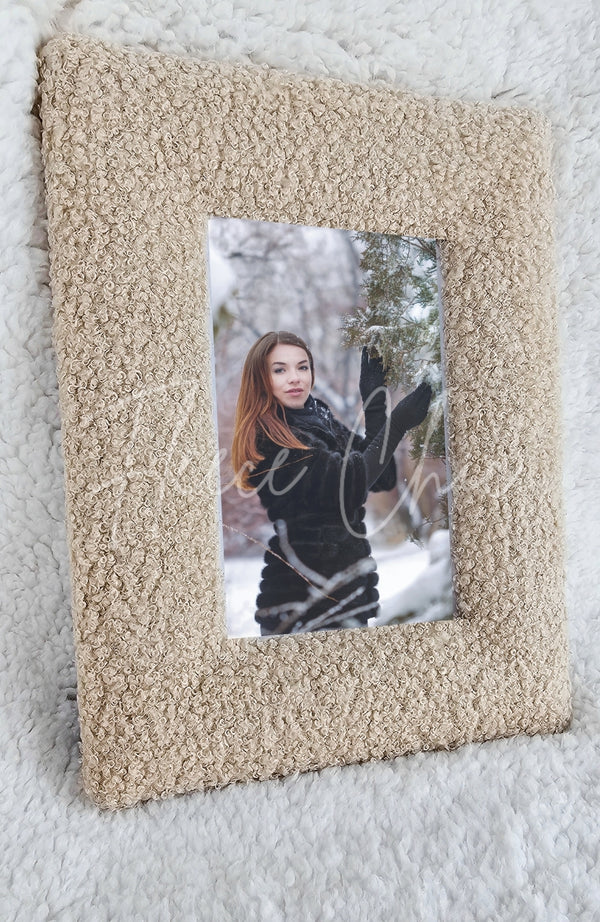 A stylish picture frame in the color Oatmeal by Fleece Chic with the image of a woman in snow framed.