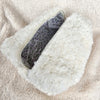 A close-up picture of a white sherpa bag with a pretty purple flower lining - Fleece Chic