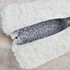 A sherpa bag with a beautiful flower lining is pictured in a close-up with its inside visible - Fleece Chic