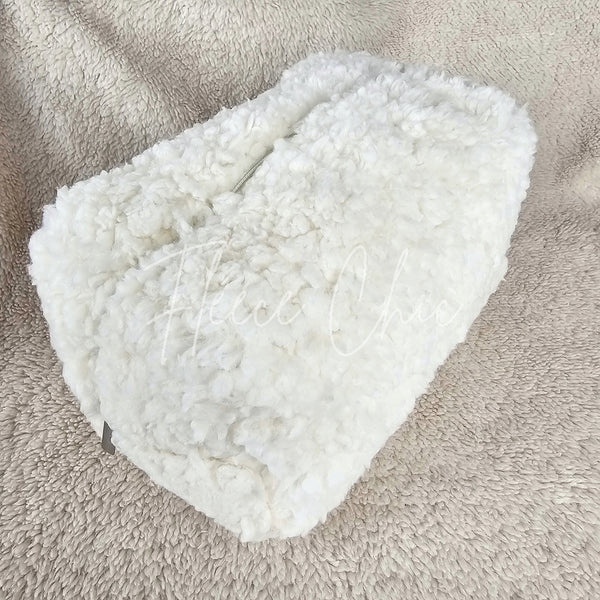 A close-up of a closed sherpa bag that has a flower lining - Fleece Chic
