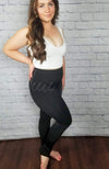 Fleece lined tights in the stirrup style that are opaque with a plush lining are worn with a white crop top - Fleece Chic