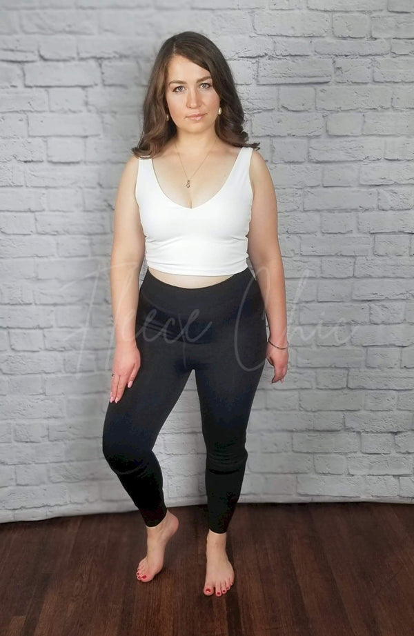 Fleece lined tights that are opaque with a plush interior in the stirrup style are worn with a white crop top - Fleece Chic