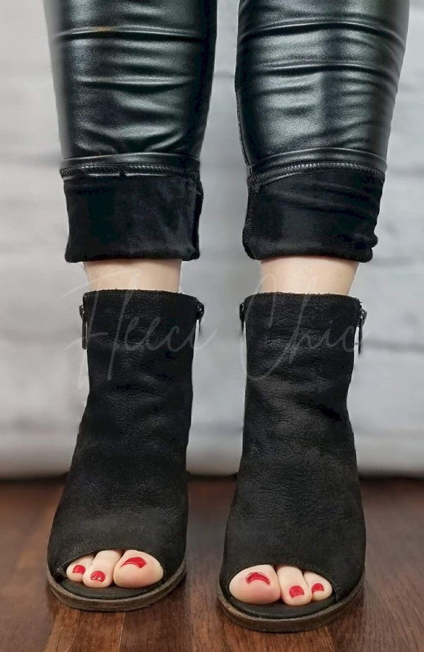 Vegan Leather Leggings by Fleece Chic have their pant legs rolled up slightly to display their soft, warm lining.