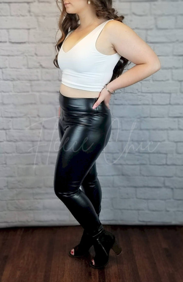 Vegan Leather Leggings are worn by a woman in a white crop top and black booties - Fleece Chic