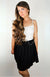 A woman wears a Thermal Tank paired with a Twirl Skirt while modeling for Fleece Chic.