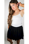 A woman wears a Thermal Tank paired with a Twirl Skirt while modeling for Fleece Chic.