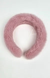 A closeup of a fur headband that is dusty pink by Fleece Chic.