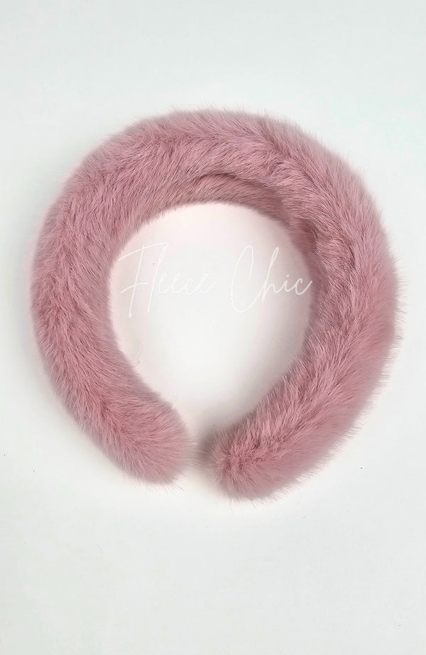 A closeup of a fur headband that is dusty pink by Fleece Chic.