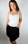 A woman wearing a twirl skirt with a thermal tank poses in front of a blank background - Fleece Chic.