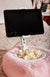 A close-up detail shot of a Tablet Pillow Stand holding a Kindle with popcorn in its bowl - Fleece Chic