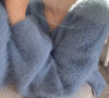 A close up shot of a blue fuzzy sweater by Fleece Chic.