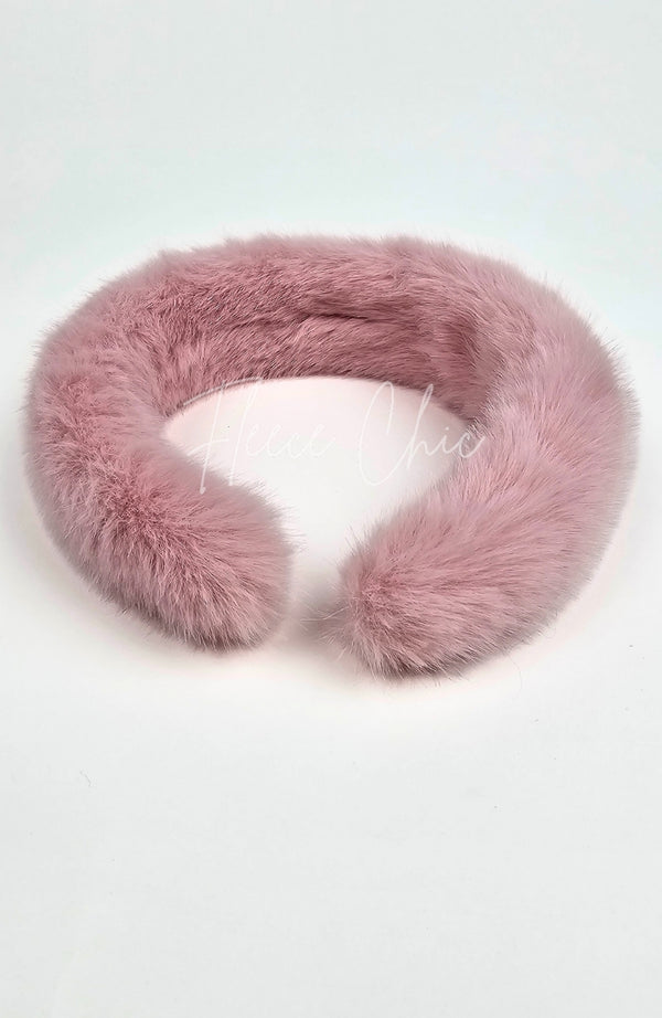 A closeup of a fur headband that is dusty pink by Fleece Chic.