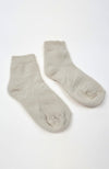A pair of beige quarter socks on a white background by Fleece Chic.