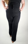 A model wears black knit pants by Fleece Chic.