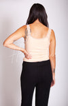 The rearview of a woman wearing a thermal tank top with lace and knit pants by Fleece Chic.