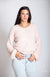 A woman wears a pink fluffy sweater that has a v neck along with light blue jeans - Fleece Chic