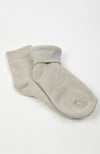 A pair of beige quarter socks on a white background with one turned inside out a little to show off its plush interior - Fleece Chic