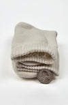 Thick folded beige quarter sock with a coin for scale on a white background - Fleece Chic