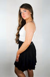 A woman wearing a twirl skirt with a thermal tank poses in front of a blank background - Fleece Chic.