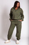 A matching set of army green colored sweats clothing is worn by an African American woman - Fleece Chic