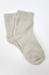 A pair of beige quarter socks on a white background by Fleece Chic.