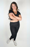 A woman wears a black pair of cozy leggings with a plush lining by Fleece Chic.