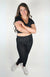 A woman wears a black pair of cozy leggings with a plush lining by Fleece Chic.