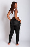 An African American woman wears a pair of black cozy leggings by Fleece Chic.