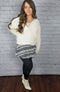Cozy tights that are black with a fleece lining are worn with a skirt, white sweater, and white boots - Fleece Chic