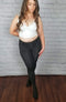 Footed tights in black with fleece lining are paired with a white v-neck crop top - Fleece Chic