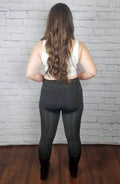 Opaque tights that have a fleece lining have their rear view displayed by a woman with long brown hair - Fleece Chic