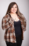 A woman smiles and poses in a brown insulated flannel and winter camisole - Fleece Chic