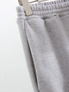 The waistband of a pair of gray fleece sweatpants is shown close up - Fleece Chic
