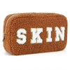 Brown chenille bag by Fleece Chic with letters spelling out the word "skin."