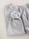 Gray fleece sweatpants have their cozy lining displayed for the camera - Fleece Chic