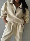 A woman in a beige sweatsuit poses for the camera with her hands in her pockets - Fleece Chic