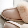House slippers that have a fleece lining and fur collar have their front faux suede and quality stitching displayed - Fleece Chic