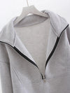 A gray fleece sweatsuit unzipped to display its cozy lining - Fleece Chic