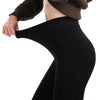 Footed tights in black have their waistband pulled to display their stretch - Fleece Chic